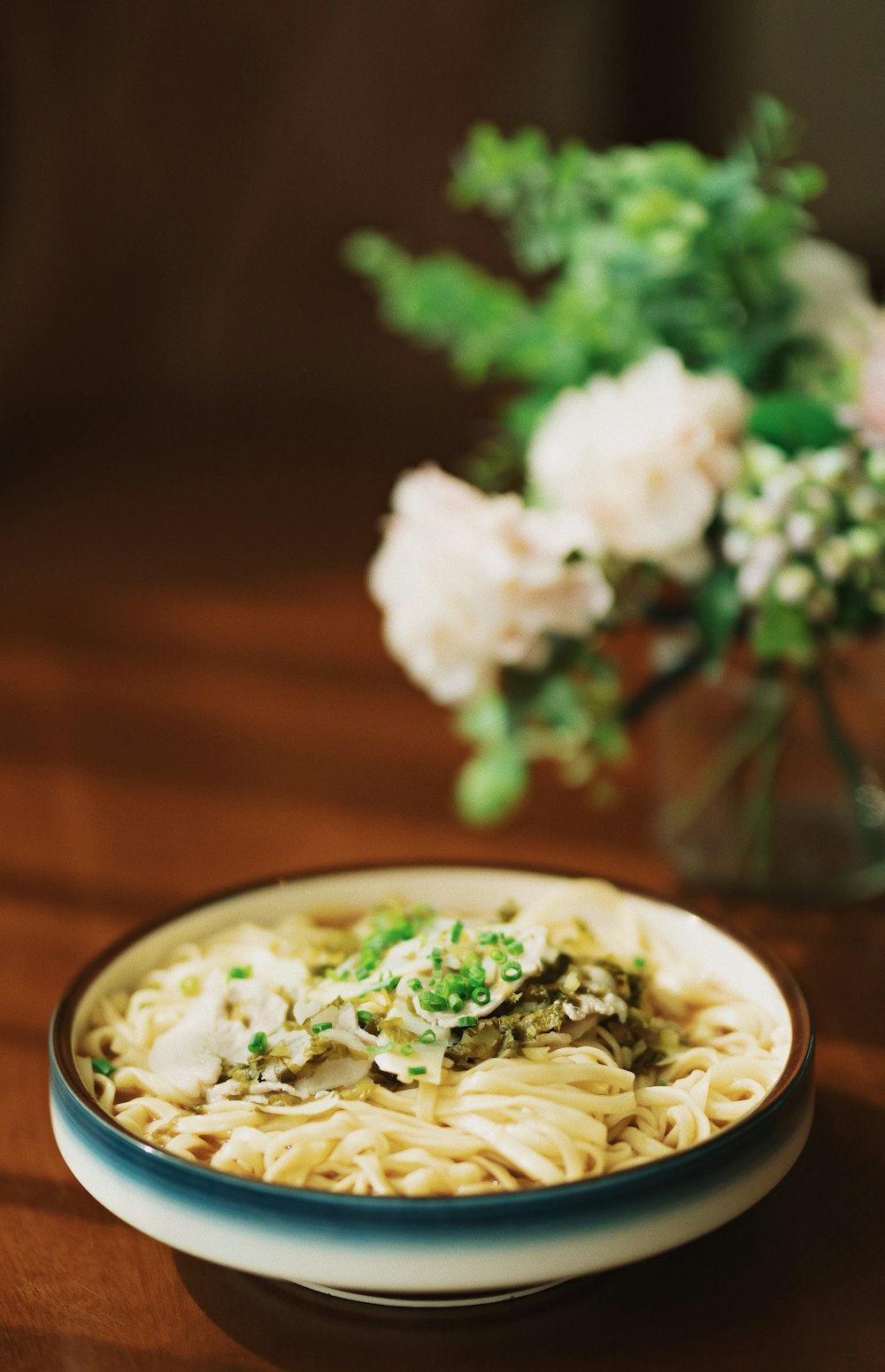 white and green ceramic bowl with soup