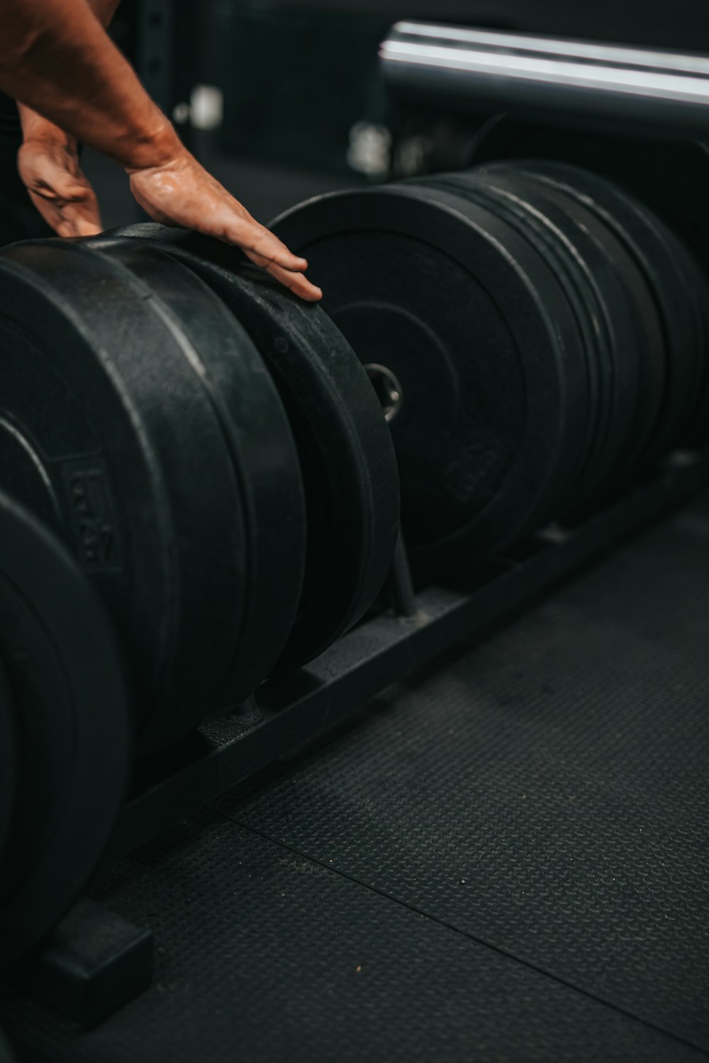 person standing on black and gray weight bench