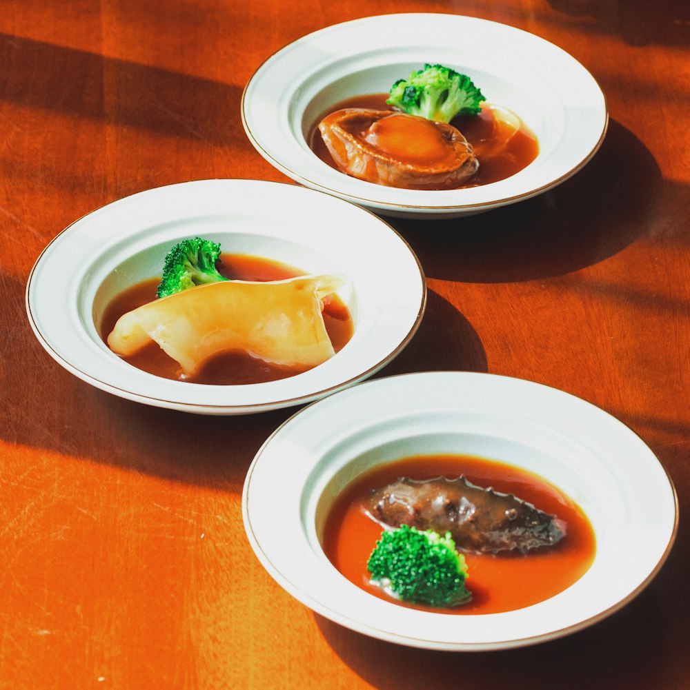 white ceramic plate with food on brown wooden table