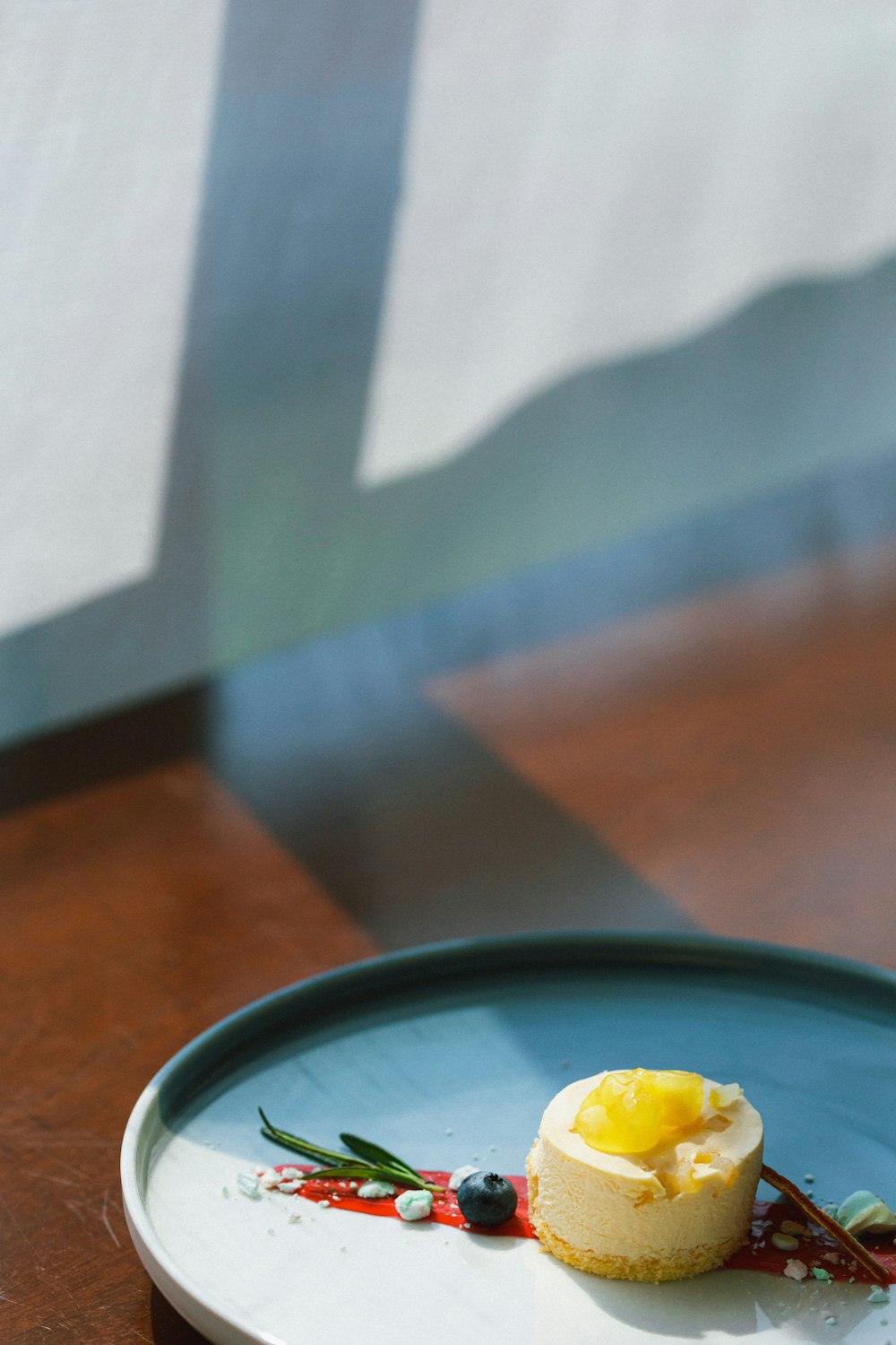 blue ceramic plate on brown wooden table