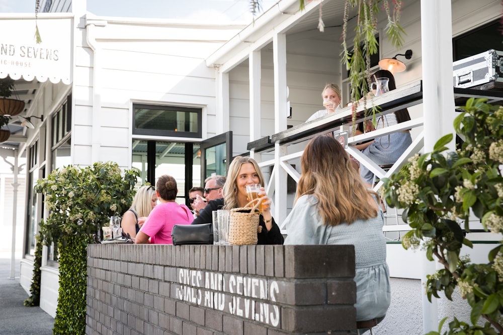 people sitting on gray concrete bench during daytime