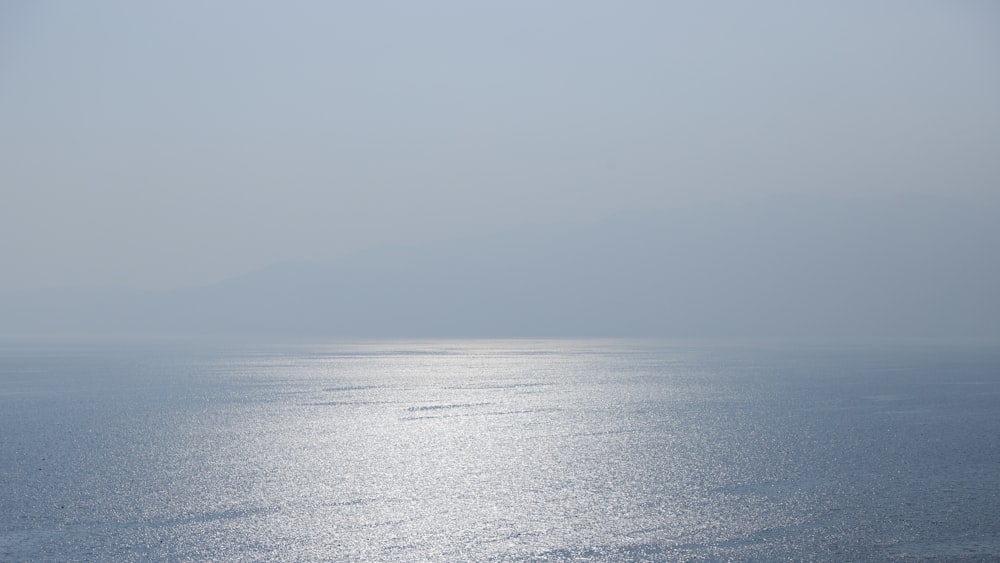 body of water under gray sky