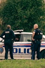A law enforcement officer discussing procedures with colleagues.