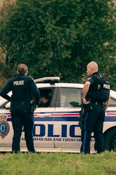 A law enforcement officer discussing procedures with colleagues.
