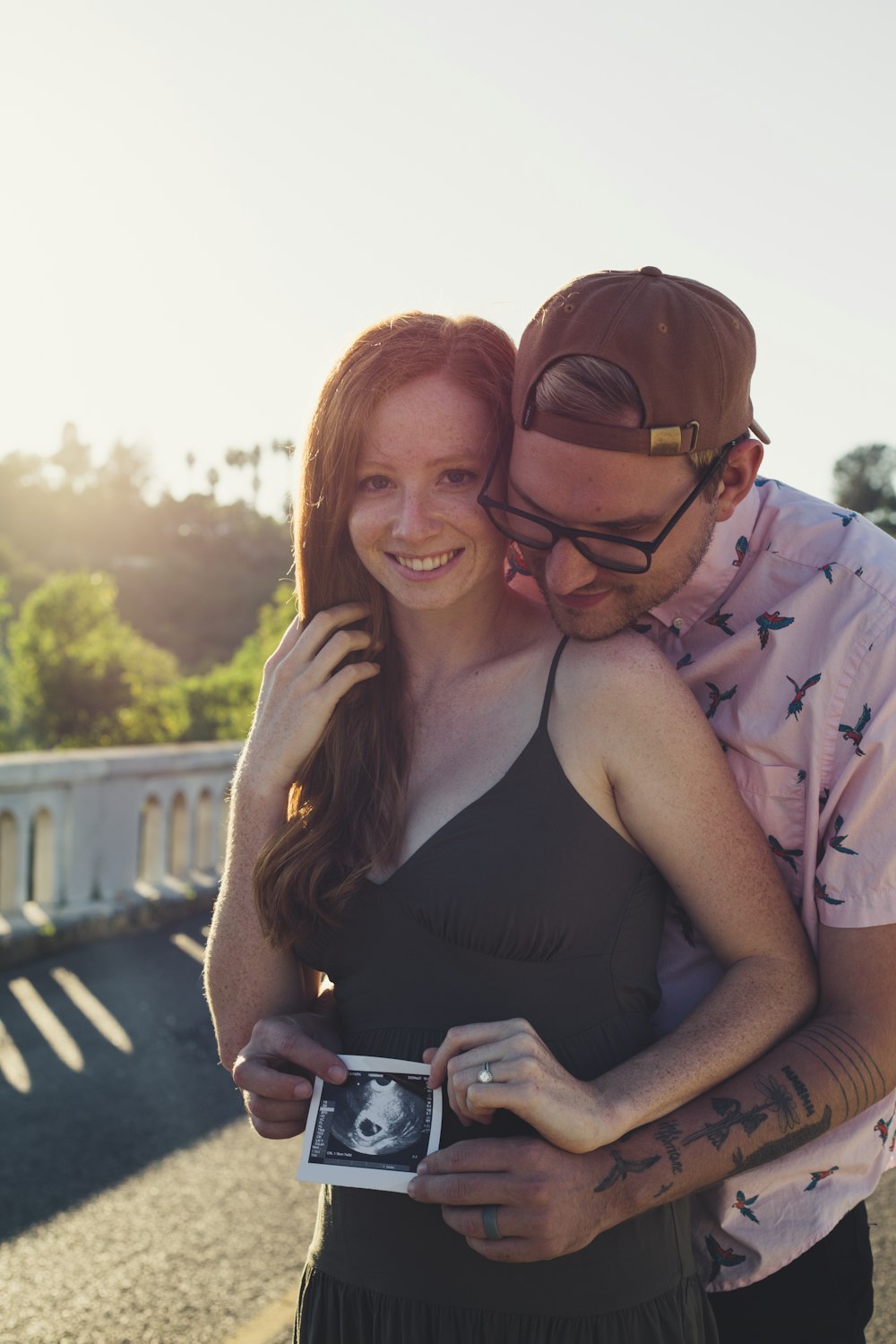 woman in black tank top beside man in blue and white plaid dress shirt