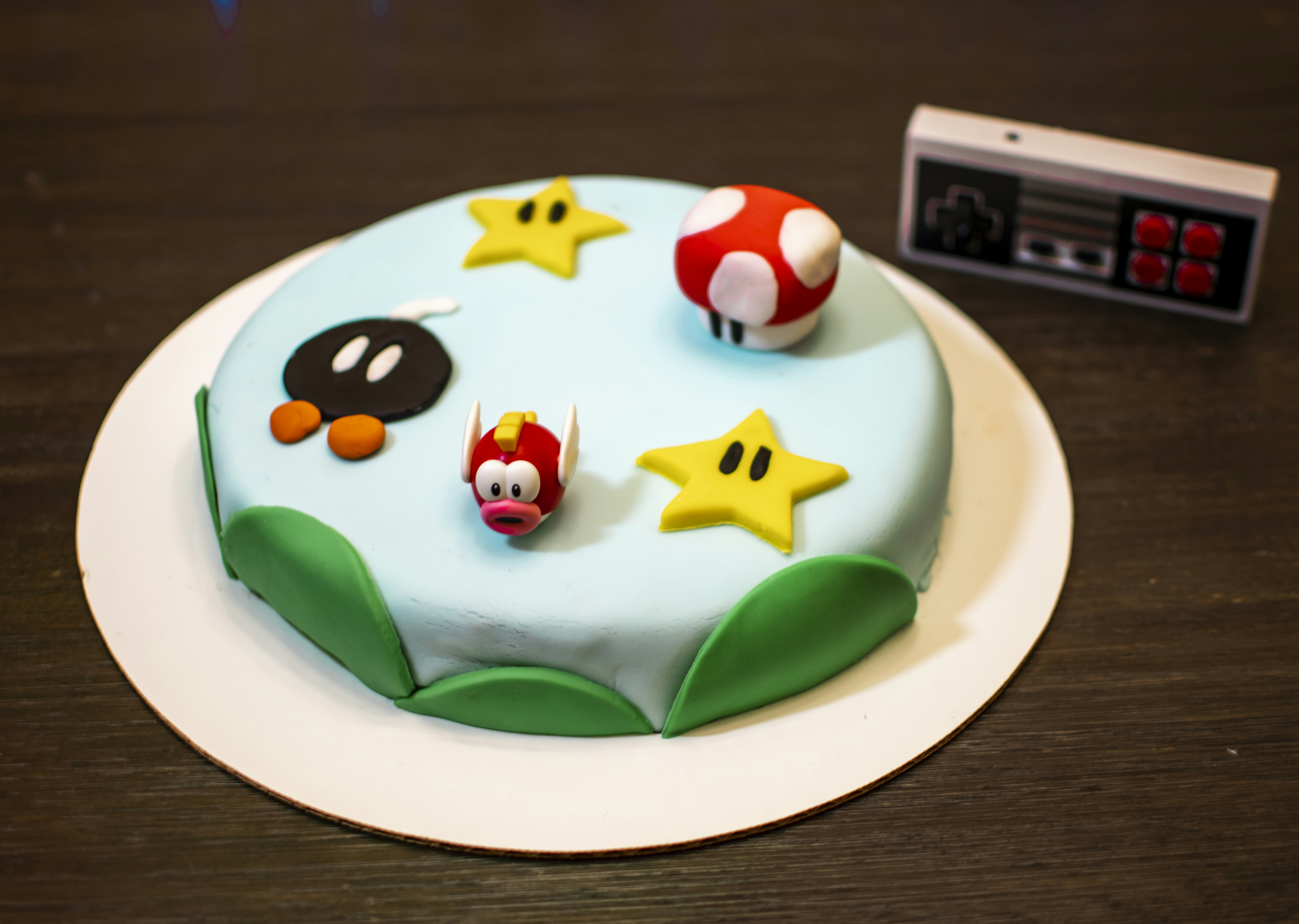 A custom-designed birthday cake decorated to look like a superhero's shield.
