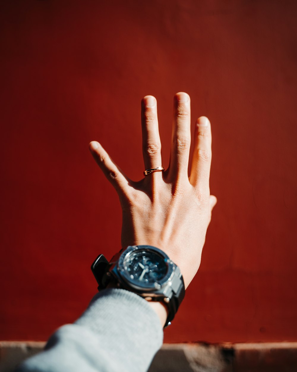 person wearing black and silver round analog watch