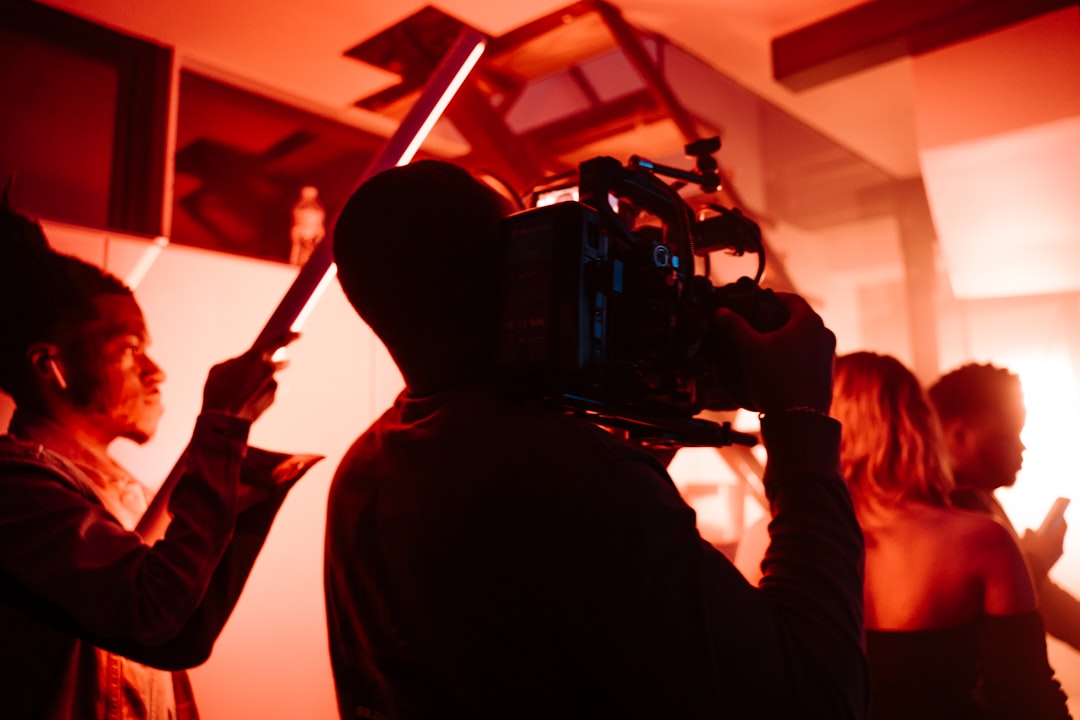 man in black jacket holding black dslr camera, Film lights