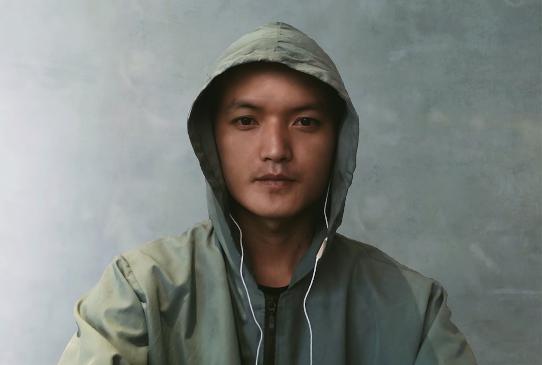 man in gray hoodie taking selfie,