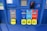 A gas station pump panel featuring four fuel options: Diesel, Regular, Extra, and Supreme+, each with distinct colors and labels. The panel includes pricing displays and a card payment slot. Each fuel option has a yellow button indicating the octane rating. The panel is predominantly blue with some black and red elements.