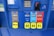 A gas station pump panel featuring four fuel options: Diesel, Regular, Extra, and Supreme+, each with distinct colors and labels. The panel includes pricing displays and a card payment slot. Each fuel option has a yellow button indicating the octane rating. The panel is predominantly blue with some black and red elements.