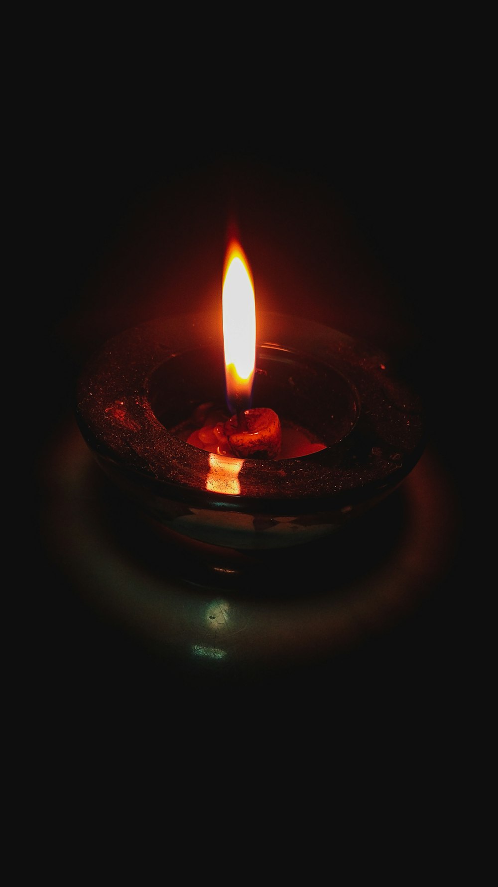 lighted candle on brown round holder