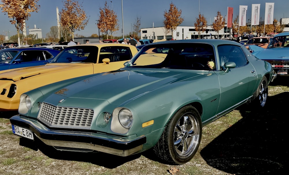 blue chevrolet camaro parked on parking lot during daytime