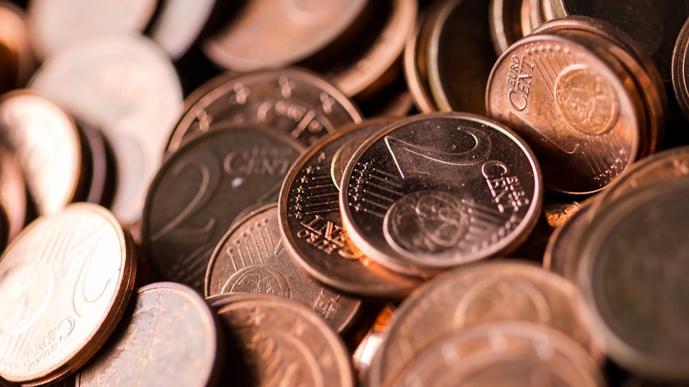 silver round coins on white surface