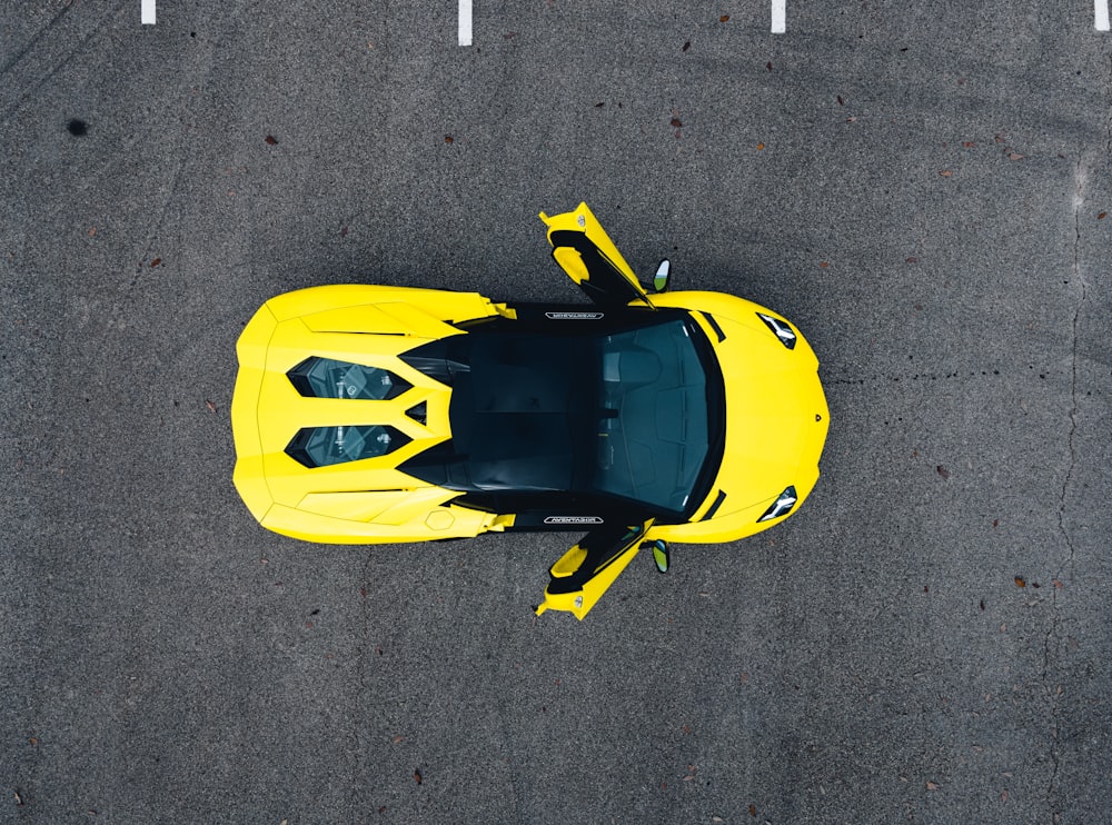 yellow and black sports car on gray asphalt road