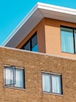 brown brick building with glass windows