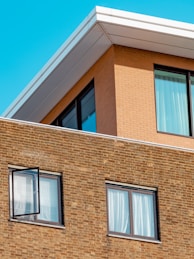 brown brick building with glass windows