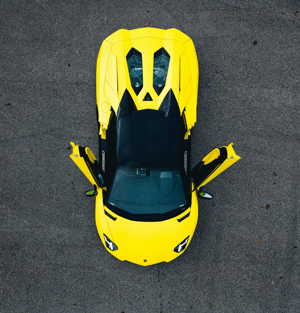 yellow and black car on gray asphalt road