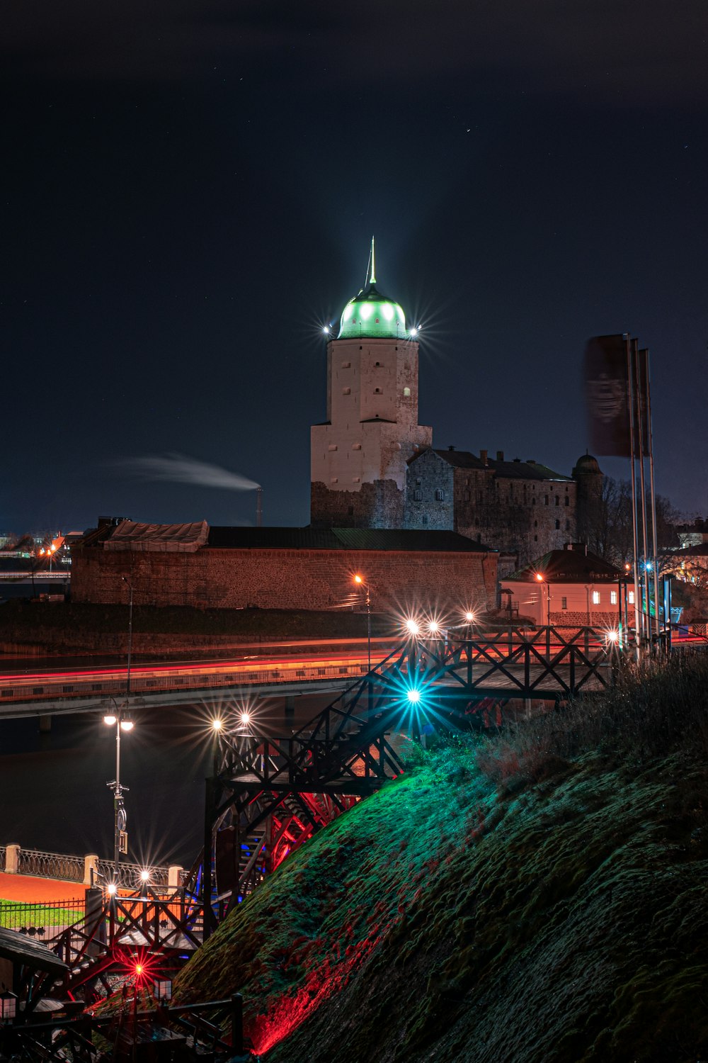 brown concrete building near bridge during night time