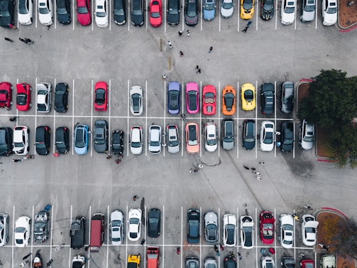 A panoramic view of a bustling car dealership lot.