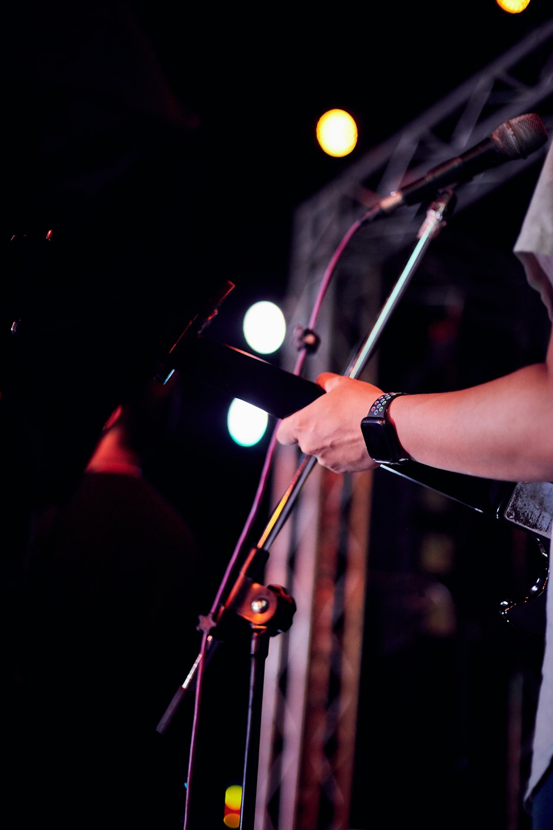 person in black shirt playing guitar