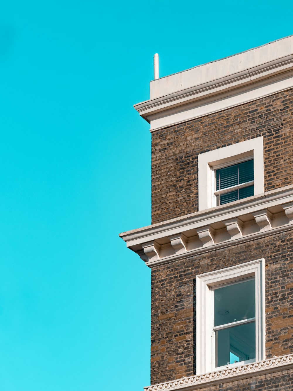 brown brick building with white window