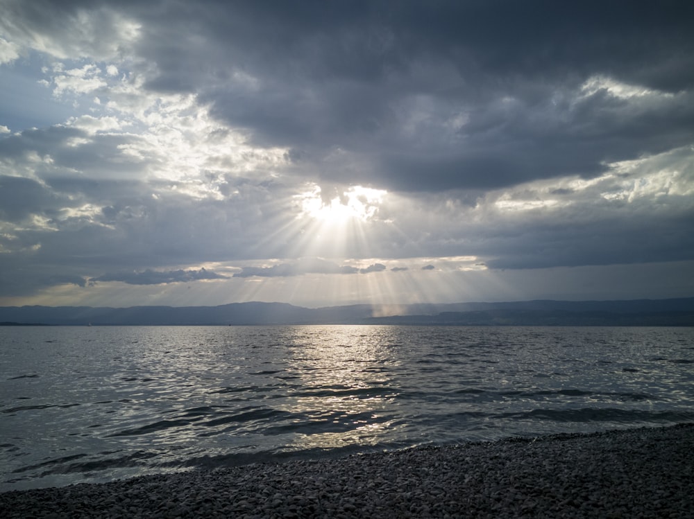 sea under blue sky and white clouds during daytime