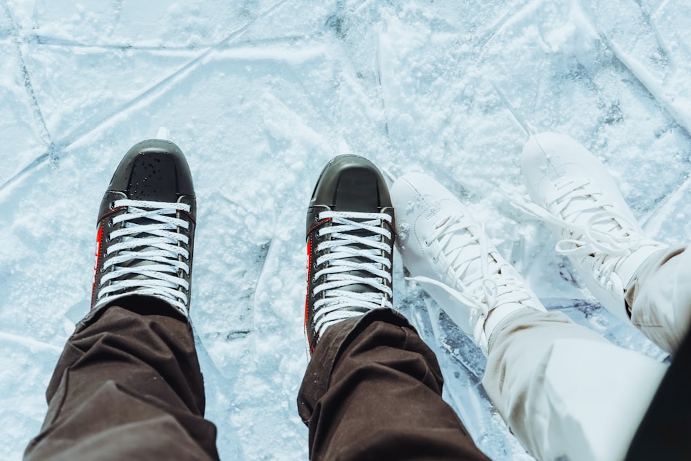 person in black and white adidas sneakers