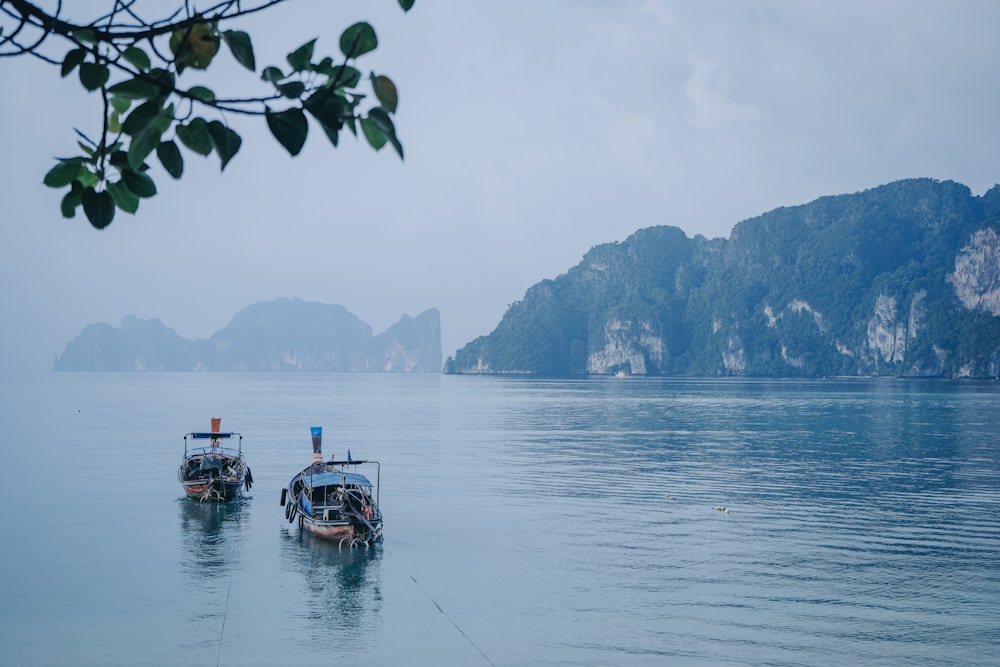 boat on water near mountain during daytime