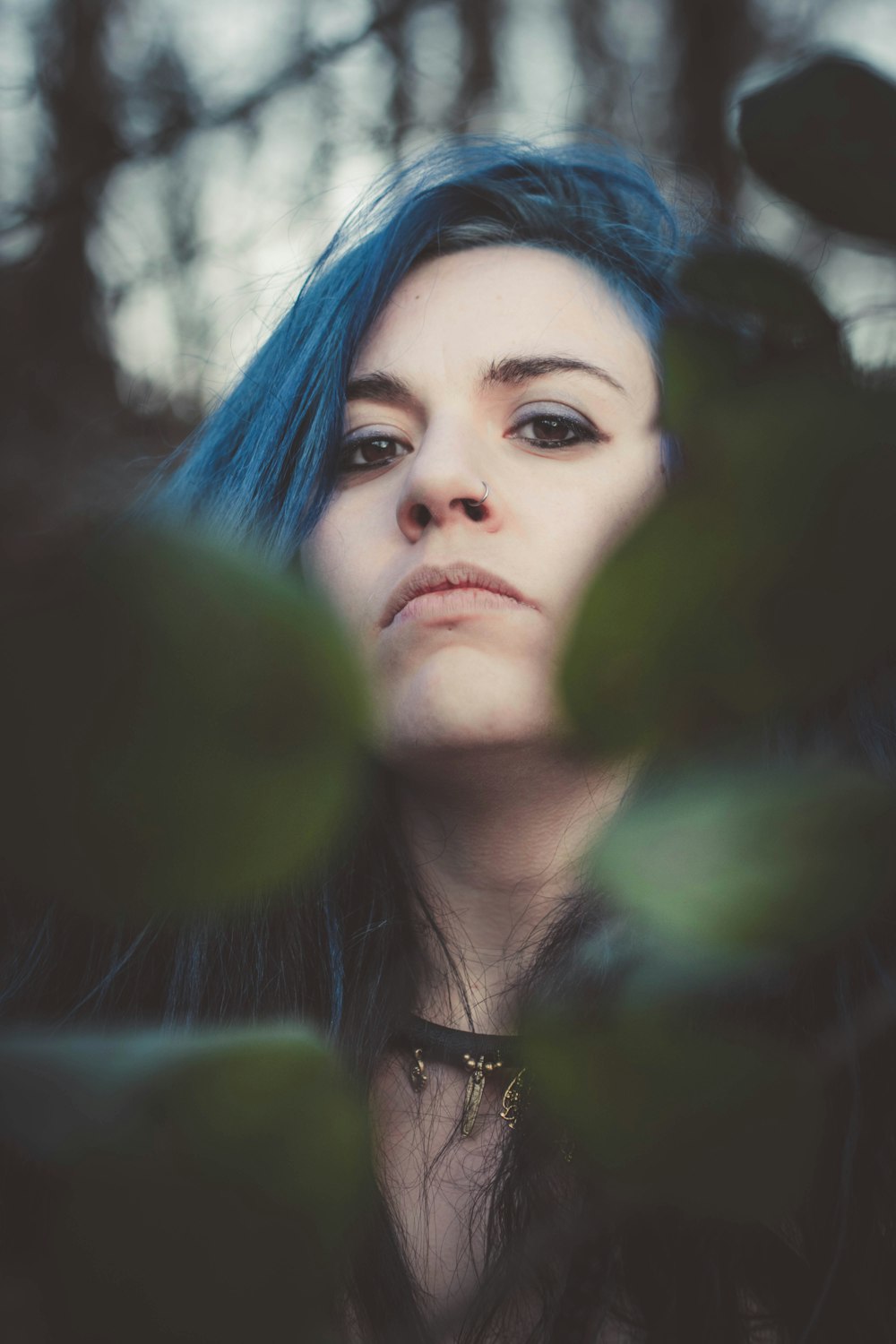 woman with blue hair in green and white shirt