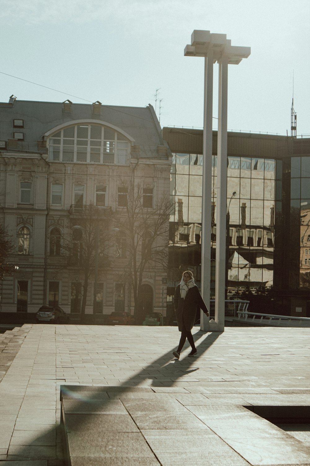 people walking on sidewalk near brown concrete building during daytime