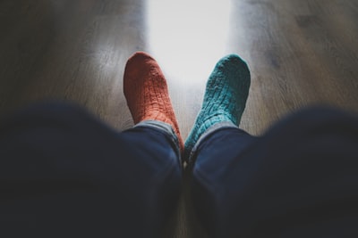 person wearing blue denim jeans and red socks odd zoom background