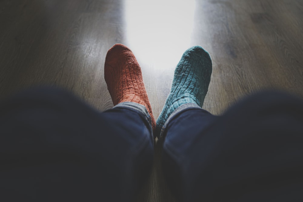 person wearing blue denim jeans and red socks