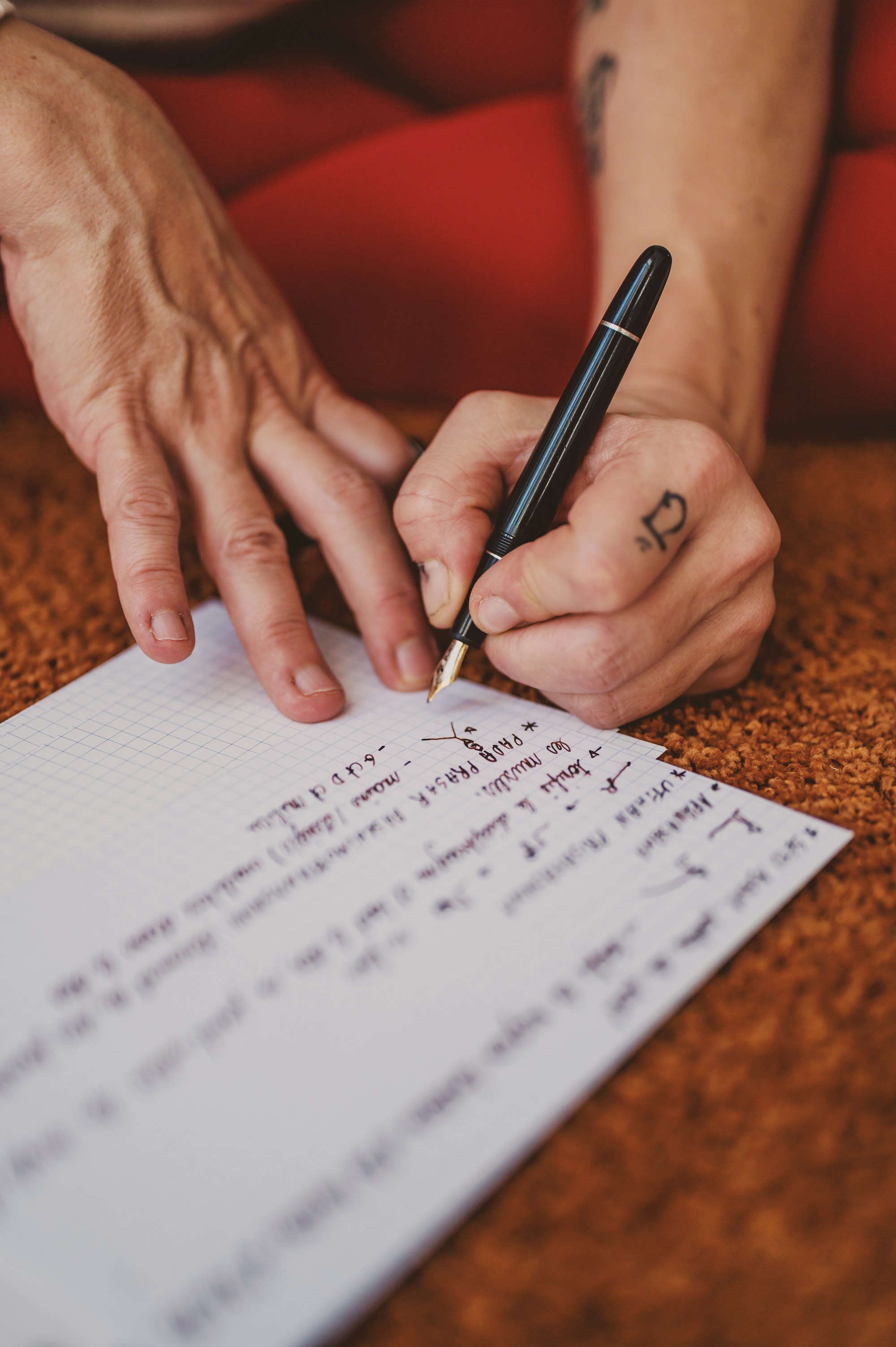 person writing on white paper