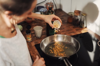 person holding stainless steel round tray with food