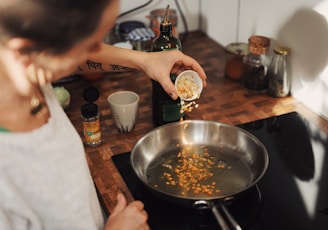 person holding stainless steel round tray with food