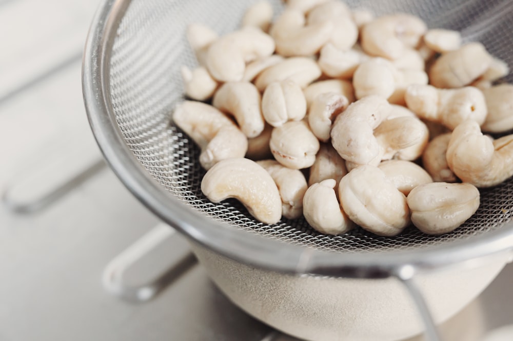 brown nuts on stainless steel strainer