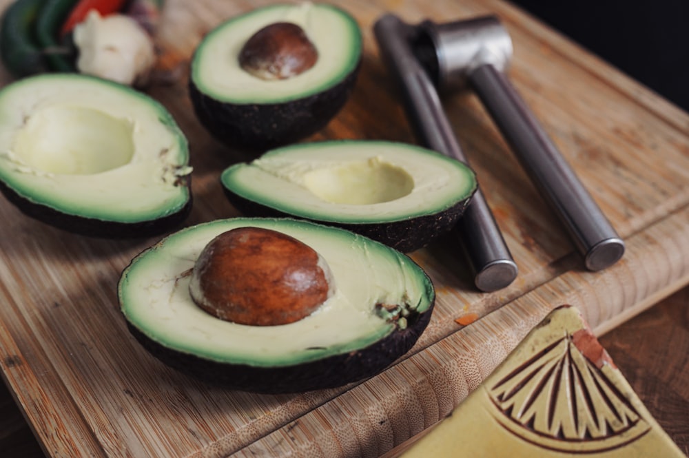 sliced avocado fruit on chopping board