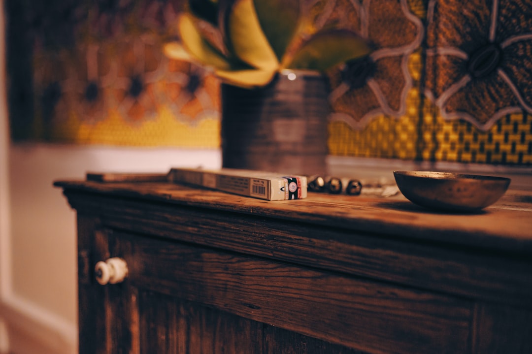 black and white remote control on brown wooden table