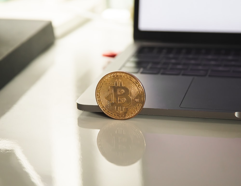 silver round coin on white table