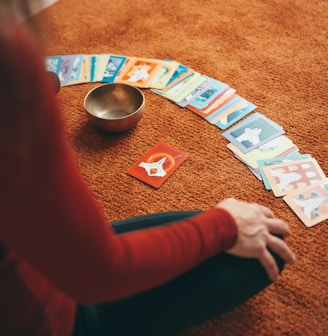 person in red long sleeve shirt holding playing cards