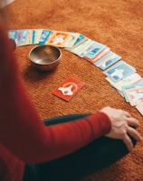 person in red long sleeve shirt holding playing cards