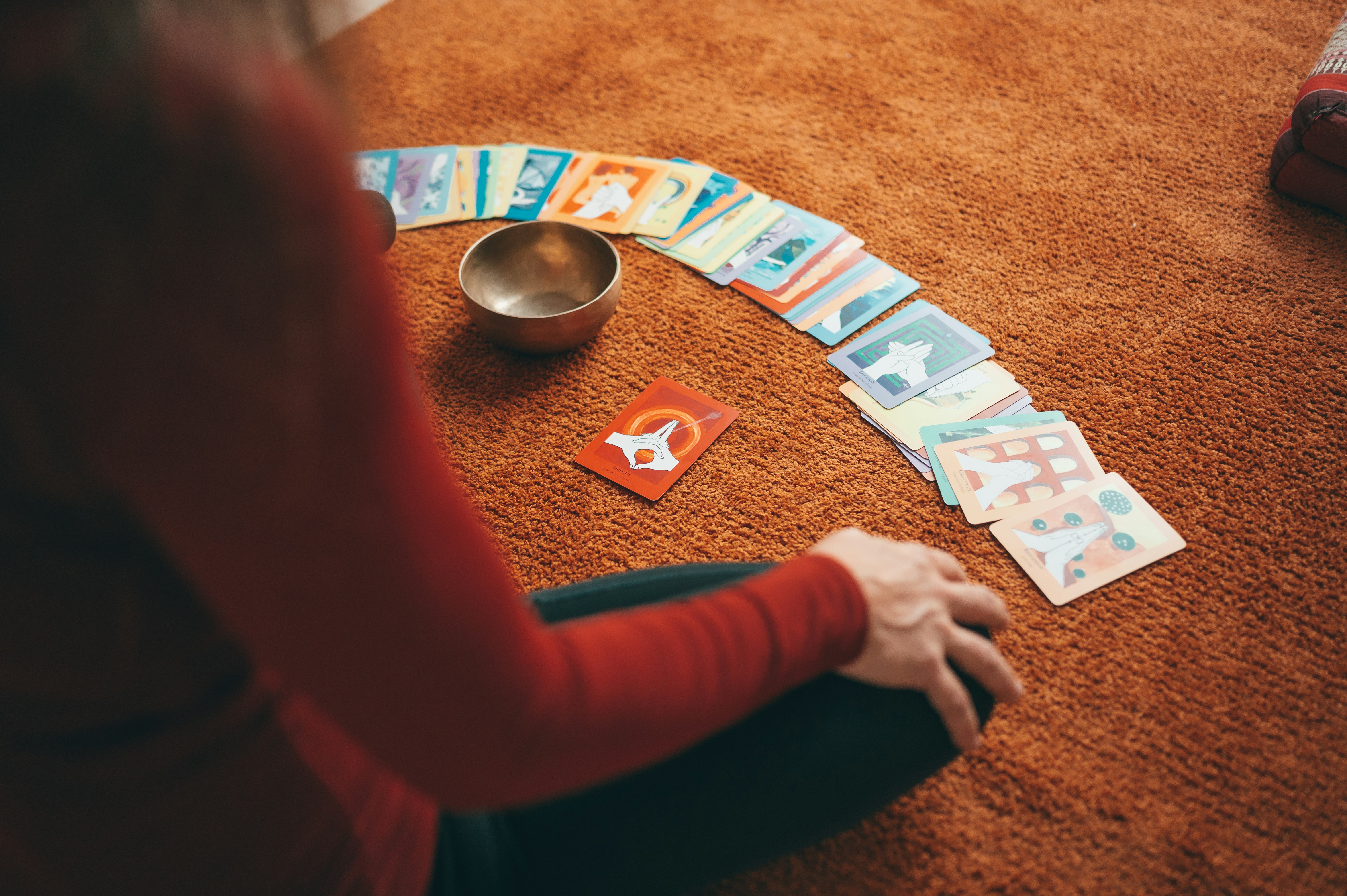 person in red long sleeve shirt holding playing cards