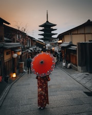 red umbrella on black and white street lamp