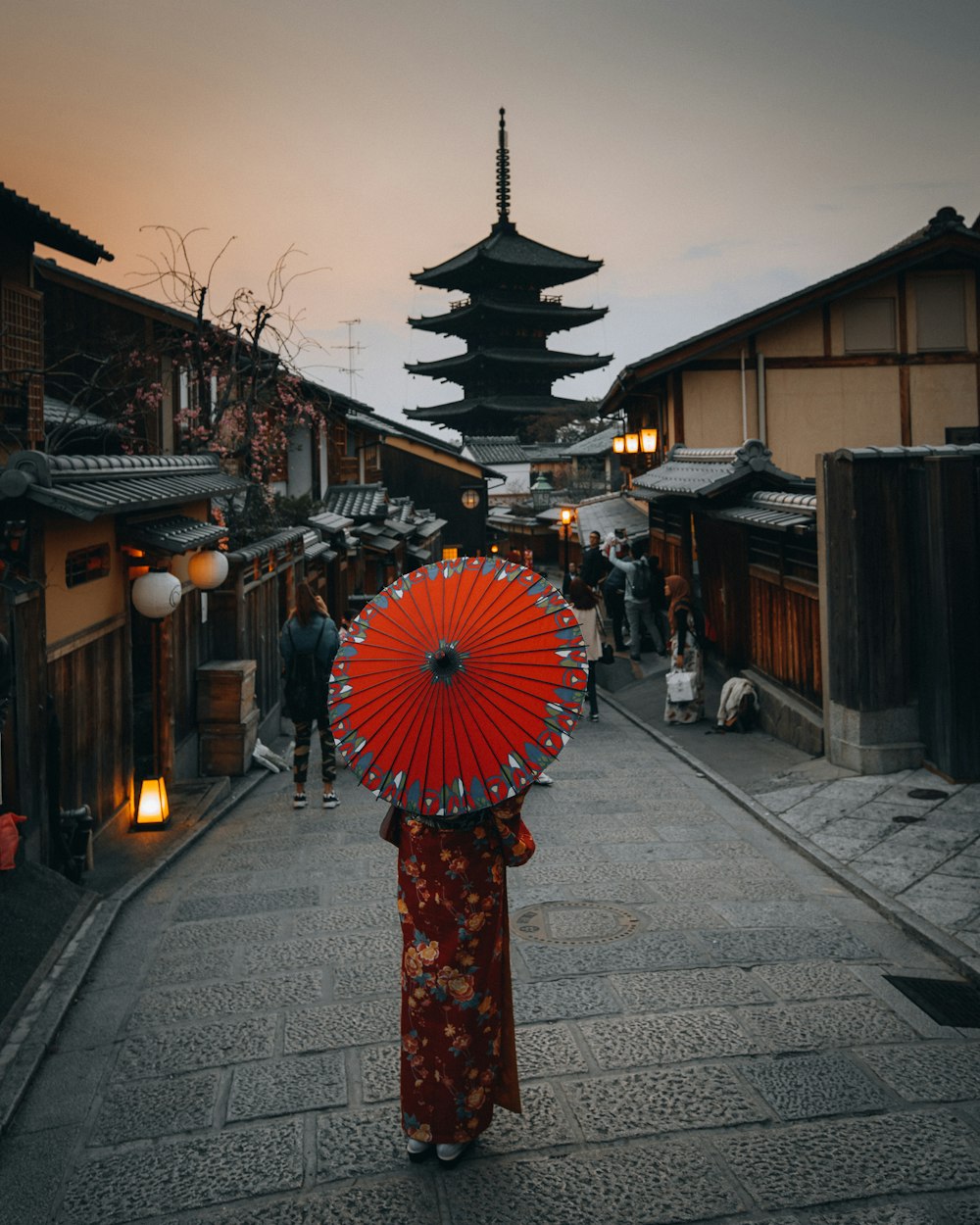 red umbrella on black and white street lamp