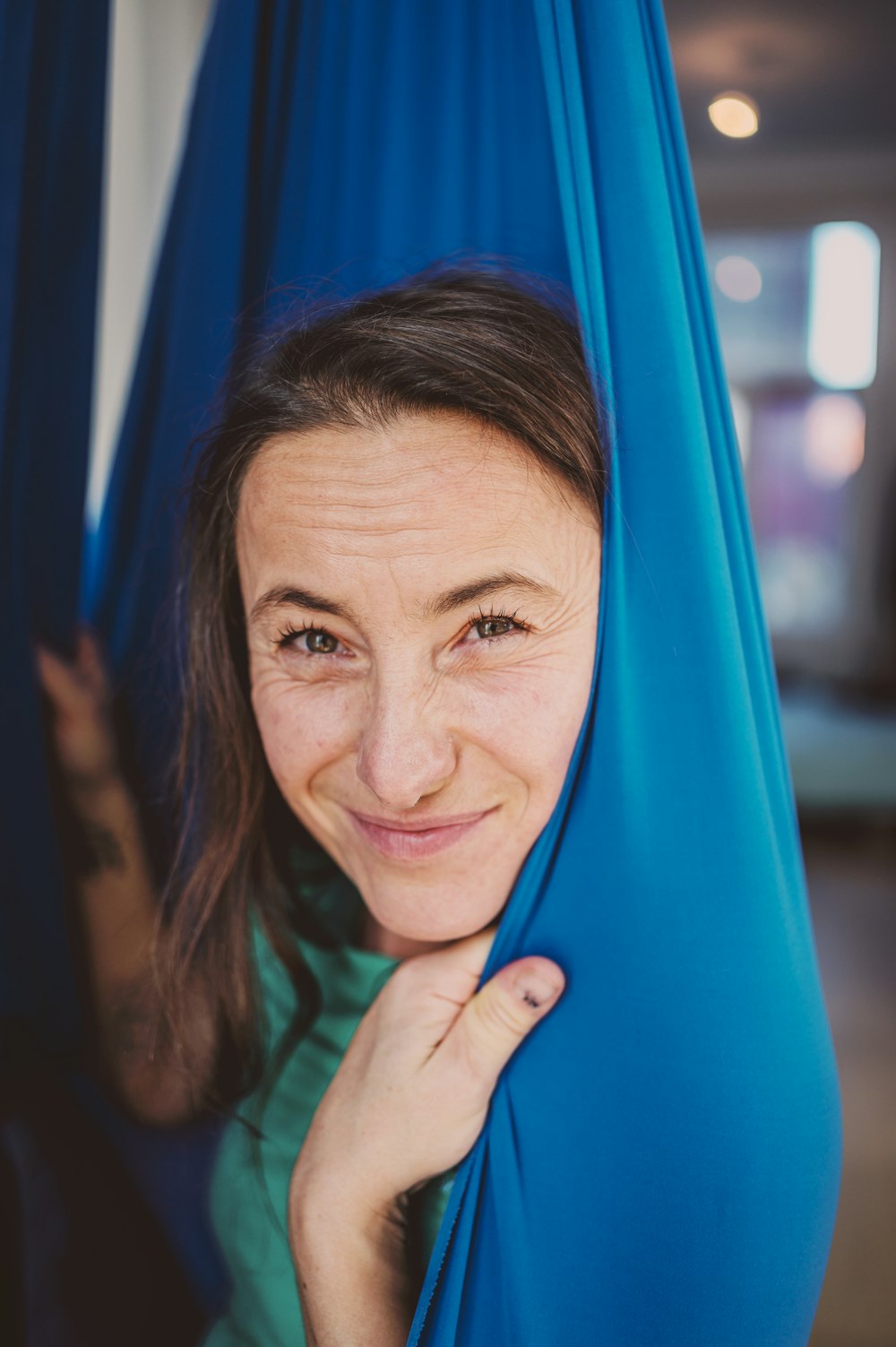 woman in green shirt smiling