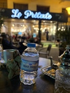 Elegant glass bottle of Royal Signature mineral water on a hotel table.