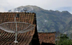 Technician installing a satellite dish on a house exterior