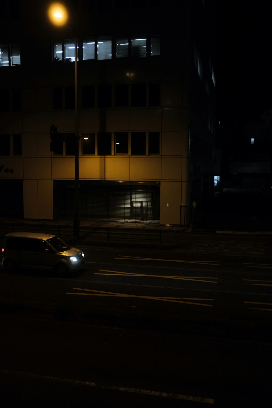 yellow car on road near building during night time