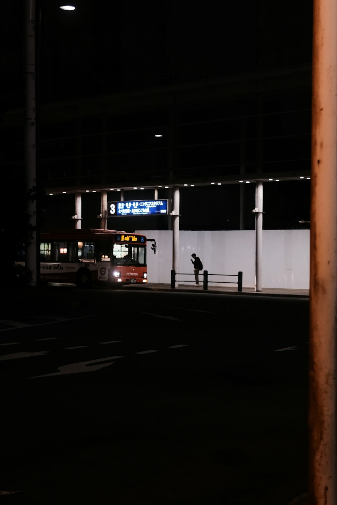 white and red bus on road during night time